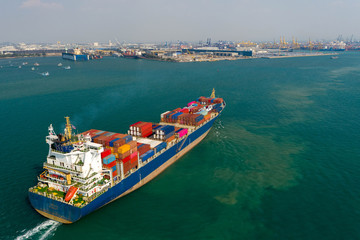 Aerial view. Container ship in pier with crane bridge carries out export and import business in the open sea. Logistics and transportation
