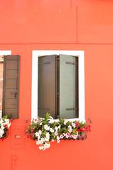 Fototapeta na wymiar Mediterranean style. Colorful window on the island of Burano Venice Italy