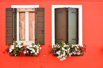 Fototapeta na wymiar Abstract colorful windows with shutters on the island of Burano Venice Italy