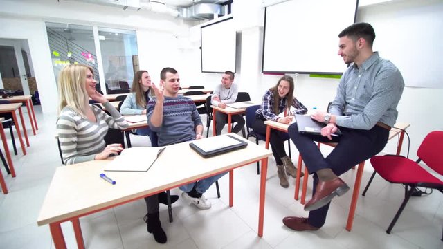 students interacting with professor in a classroom