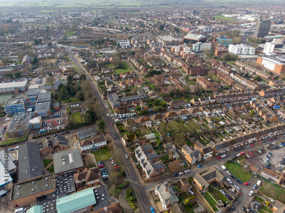 Wall mural Aerial photo of the town of Aylesbury in the UK showing roads, residential properties, rows of houses and businesses.