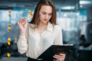 Fototapeta premium Corporate revenue growth. Market leadership. Astounded woman executive looking at annual business statistics.