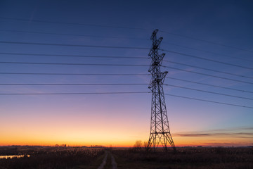 Silhouette of electrical tower during a beautiful dusk in the Dutch countryside.
