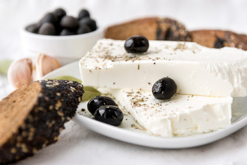 Greek feta cheese, olives, piece of bread