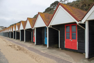 Fototapeta na wymiar Beach huts on the beach in Bournemouth.