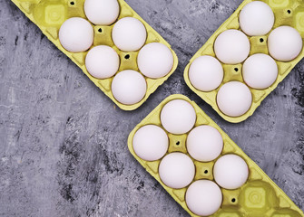 Chicken painted eggs in box on stone background.