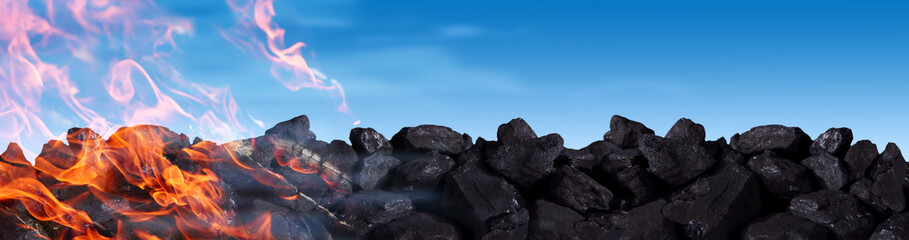 A pile of black coal burns and releases carbon dioxide into the atmosphere between other poisons.