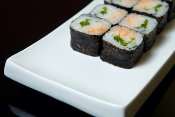 Traditional fresh japanese set sushi rolls on a black background