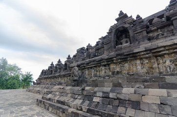 Fototapeta na wymiar Brahma Vihara Arama in northern Bali is built in the style of the famous Borobudur temple in cloudy day