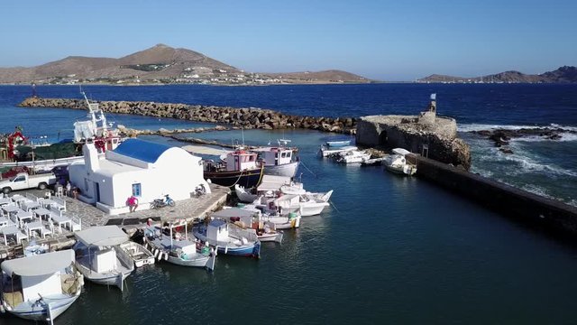 Aerial bird's eye view video taken by drone of iconic and picturesque port of Naousa village, Paros island, Cyclades, Greece