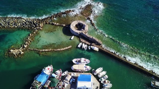 Aerial bird's eye view video taken by drone of iconic and picturesque port of Naousa village, Paros island, Cyclades, Greece