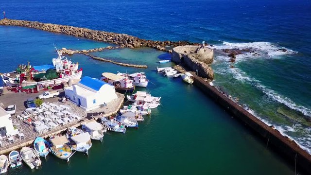 Aerial bird's eye view video taken by drone of iconic and picturesque port of Naousa village, Paros island, Cyclades, Greece