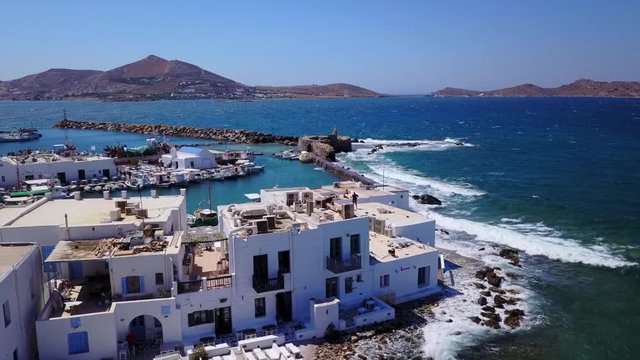 Aerial bird's eye view video taken by drone of iconic and picturesque port of Naousa village, Paros island, Cyclades, Greece