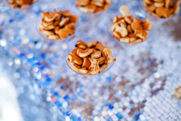 Candy bar for kids party. Snacks, cookies fish shaped on the elegant glasses. Summer season delicious on the party