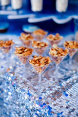 Candy bar for kids party. Snacks, cookies fish shaped on the elegant glasses. Summer season delicious on the party