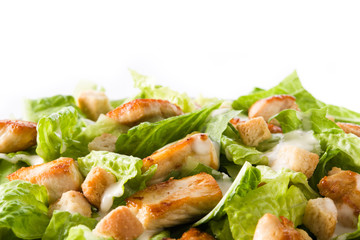 Close up of caesar salad with lettuce,chicken and croutons isolated on white background. Copyspace