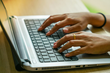 female hands on laptop keyboard