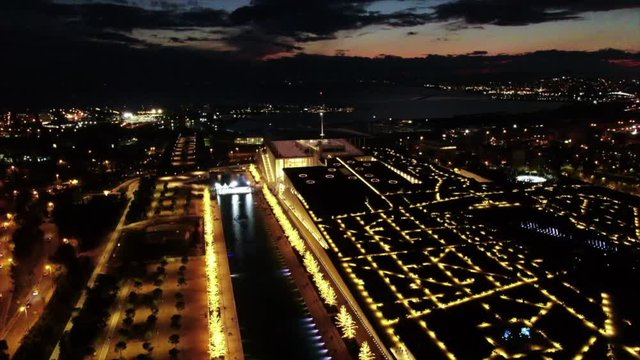 Aerial drone night video of iconic public settlement of illuminated Stavros Niarchos Foundation and cultural centre during Christmas time, Attica, Greece