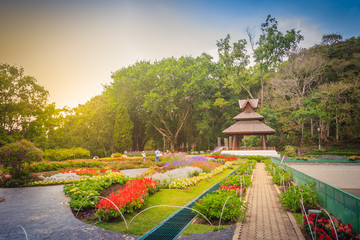 Colorful landscape view of flower garden and northern Thai's style wooden pavilion at Bhubing palace, Chiang Mai, Thailand.