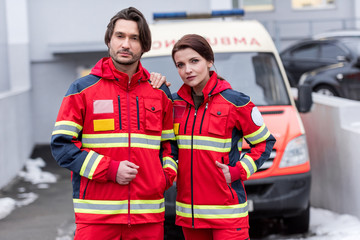 Tired paramedics in red uniform standing in front of ambulance car © LIGHTFIELD STUDIOS