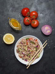 Asian Fish Salad on the black table. Top view. 