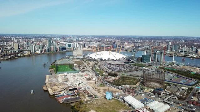Aerial drone bird's eye view video cruising in river Thames near iconic concert Hall of O2 Arena, London, United Kingdom