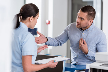 Stressed patient talking to nurse in clinic
