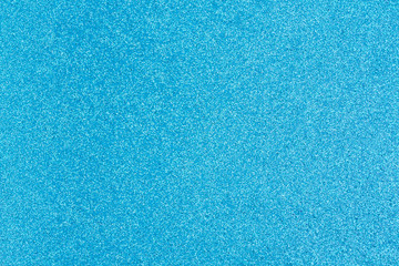 Bright blue glitter paper background with copy-space for your message and useful for textures of...