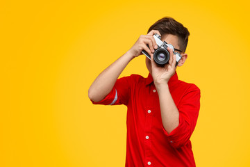 Anonymous boy with photo camera