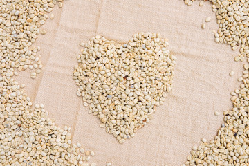 The heart form coffee beans under sun to dry background of coffee bean