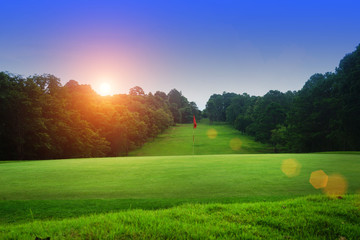 Naklejka premium The evening golf course has sunlight shining down at golf course in Thailand