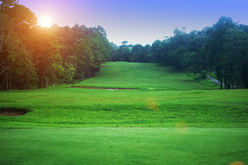 Fototapeta premium The evening golf course has sunlight shining down at golf course in Thailand