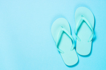 Blue flip flops on blue background.