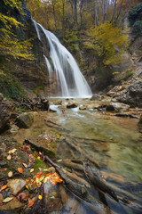 Picturesque waterfall Jur-Jur, stones in foreground, waterfall in mountains of Crimea