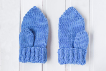 Blue mittens. Knitting with love. White background. 