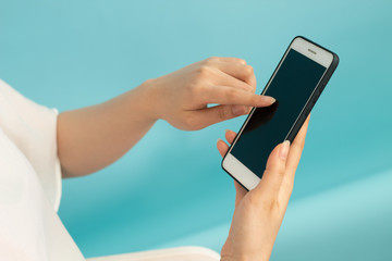 girl with smartphone and blue background for network concept