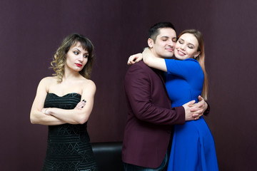 A woman without a partner is jealous of a loving couple.
