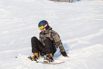 Fototapeta na wymiar Man on the snow. Winter sport. Snowboarding in the mountains. 