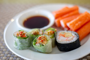 The dish of sushi and orange crab bar with the soy sauce in the restaurant.