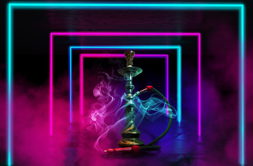 Hookah with smoke on the background of a concrete pavement with multi-colored laser beams, neon light, smoke