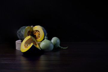 Still Life of Pumpkin and calabash thai vegetables on dark background and black wall