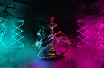 Hookah with smoke on the background of a concrete pavement with multi-colored laser beams, neon...