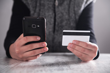 Hands with smartphone and credit card. Shopping