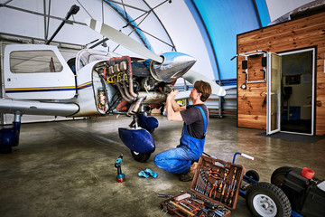 Replacing the defective parts of the aircraft service worker.