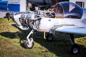 Lightweight single-engine aircraft ready for engine maintenance.