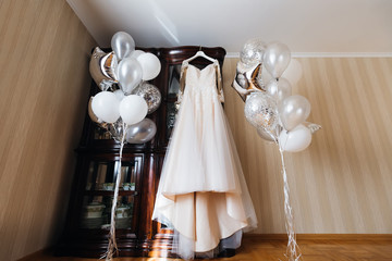 lace wedding dress on the closet. inflatable balls in the room