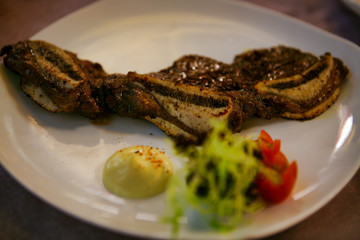 Chinese dish of fried beef with underwire served on a white plate. 