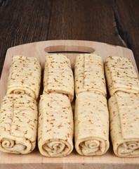 Pancake rolls on a wooden cutting board