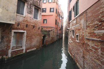 Fototapeta na wymiar Ancient building surround with water in Venice on the canal, lifestyle in Italy, boat trip in Venezia, commercial advertisement