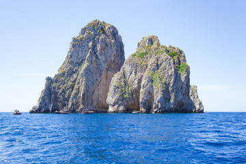 Fototapeta na wymiar Faraglioni rocks, Capri island, Italy. Mediterranean Sea summer coastal landscape. 